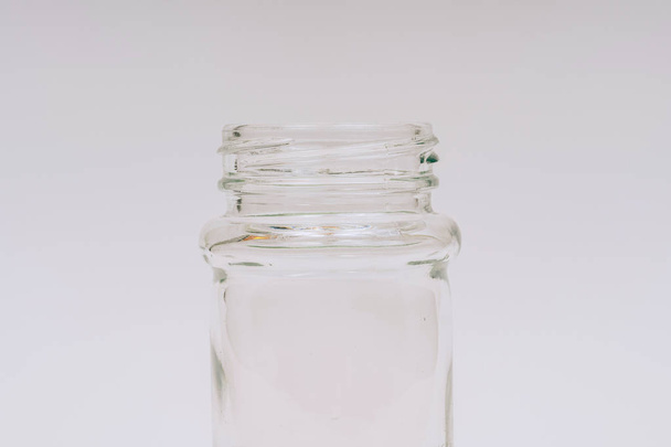 Glass jar for seasoning on white background. A small jar of glass. - Fotografie, Obrázek
