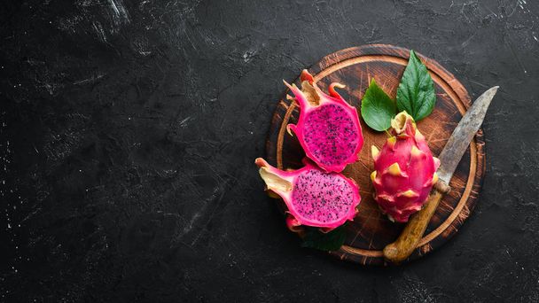 Red Pitahaya on a black background. Fruit Dragon. Tropical Fruits. Top view. Free space for text. - Foto, Bild