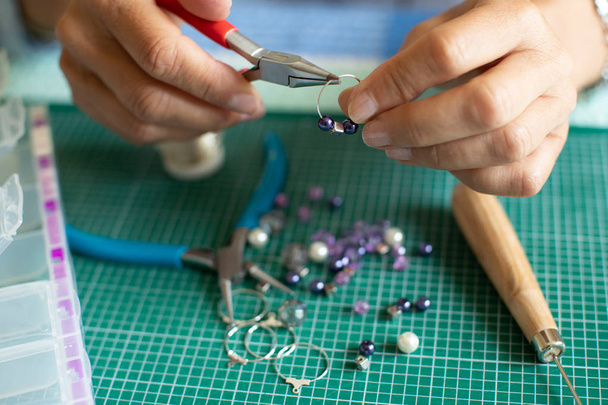 Close Up Of Senior Woman Making Jewellery Earrings At Home - Foto, Bild
