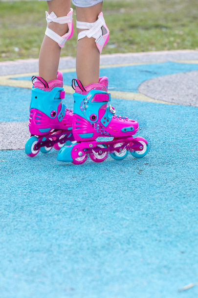 Little girl playing with roller skates - Photo, image