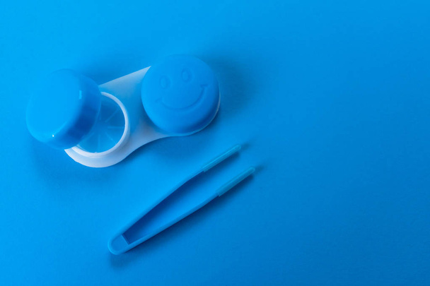 Blue container for contact lenses on blue background - Photo, Image