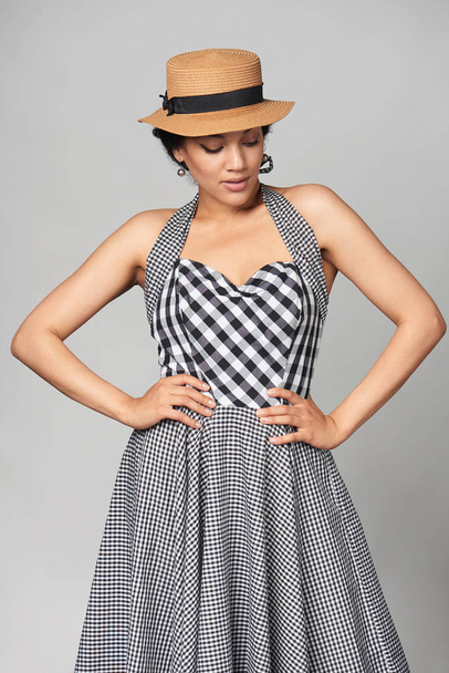 Mixed race woman in chequered summer dress and canotier straw hat - Foto, Imagem