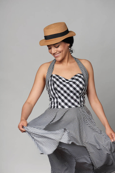 Mixed race woman in chequered summer dress and canotier straw hat - Foto, Imagem