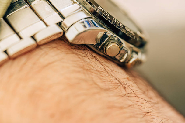 Metal watch on the man's hand. Wrist watch silver. - Zdjęcie, obraz