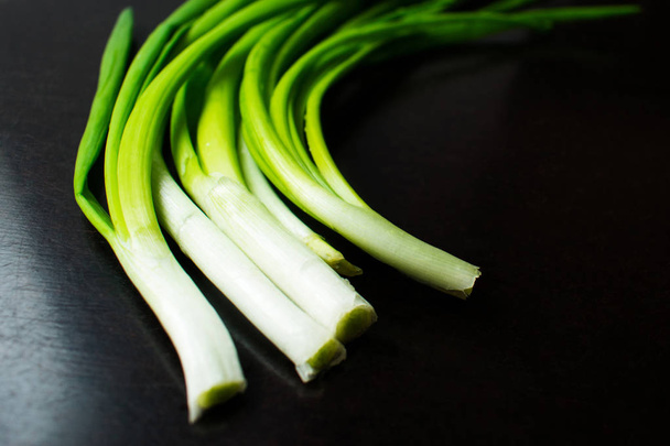Green onion on black background - Photo, Image