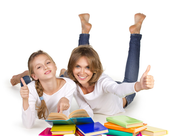 Mother and daughter couching reading books - Foto, Imagem