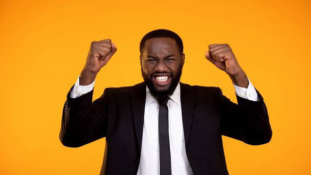 Extremely happy black employee smiling and making yes gesture, getting promotion - Fotoğraf, Görsel