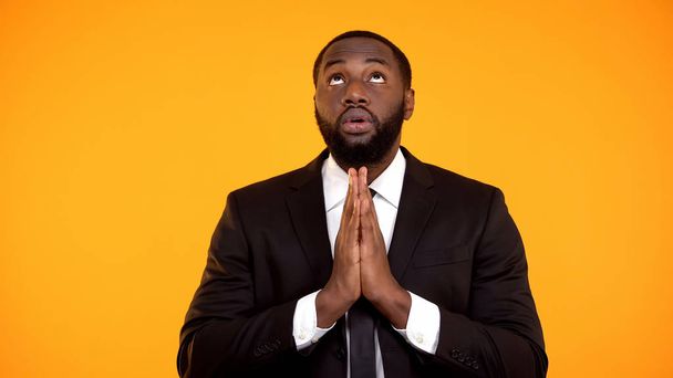 African-american male in suit praying and looking up, faith, asking for success - Zdjęcie, obraz