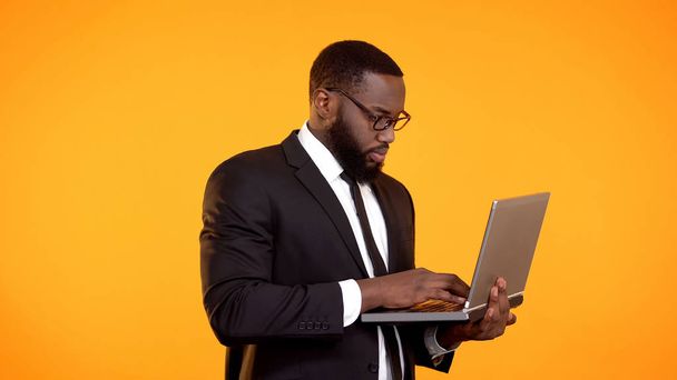 Afro-american businessman working on laptop, career growth, project development - 写真・画像