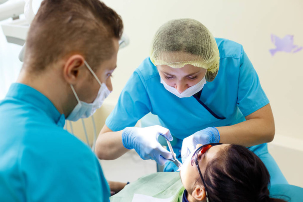 Dentist at work in the office. Female professional doctor stomatologist at work. - Valokuva, kuva