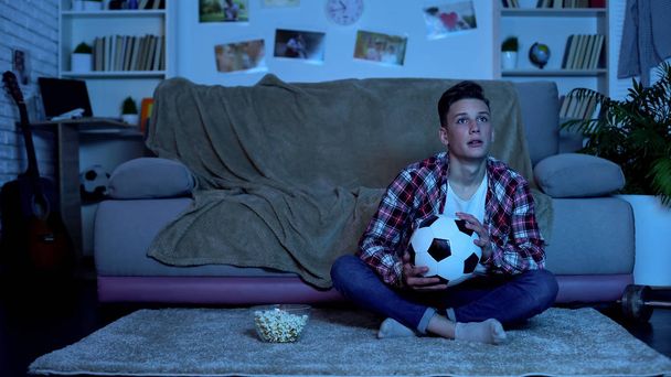 Emotional student watching soccer match on tv, national team winning game - Фото, зображення