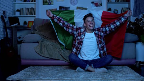 Teenager with Italian flag cheering favorite football team home, sports event - Photo, Image