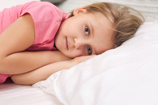 adorable little child girl smiling after waking up - Foto, imagen