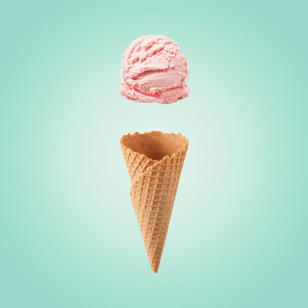 Pink ice cream scoop with ice cream cone on bright background. Minimal summer concept. - Photo, Image