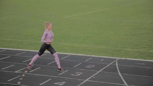 Girl preparing to run at the city stadium. - Footage, Video