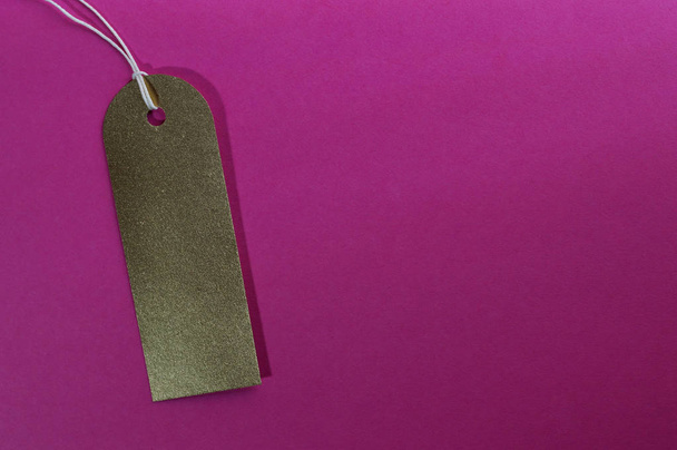 gold curved rectangle paper tag on pink background - Valokuva, kuva