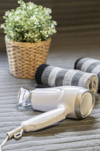 Hair dryers and towels placed on the table in the house - Photo, Image