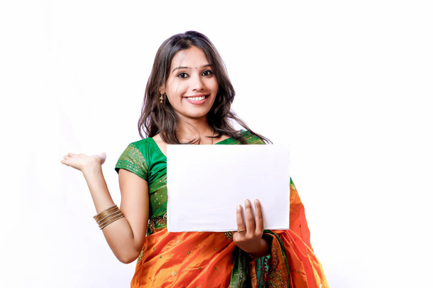 Young beautiful Indian woman in traditional sari and showing board - Fotografie, Obrázek