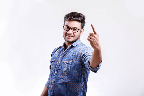 Handsome young Indian man showing thumps up isolated over white background - Photo, Image