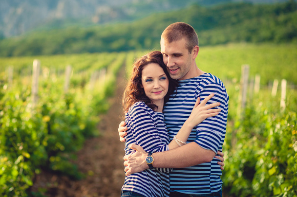 Couple in striped shirts in the vineyard - 写真・画像