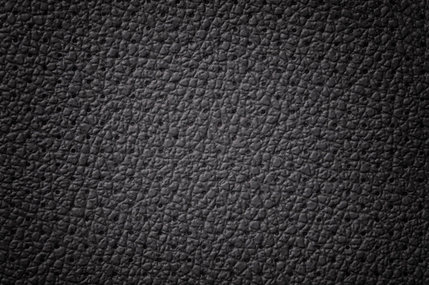 Perforiertes schwarzes Leder Textur Hintergrund, Nahaufnahme. Graue Kulisse aus faltiger Haut. - Foto, Bild