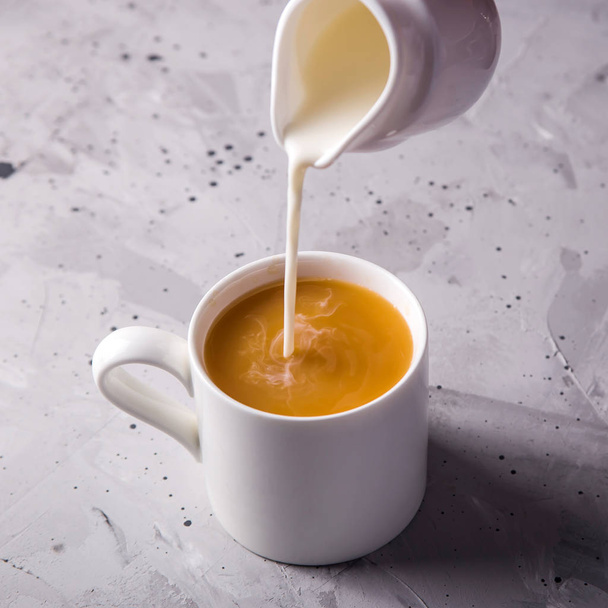 Masala tea in white minimalist cups on a gray table - Fotoğraf, Görsel