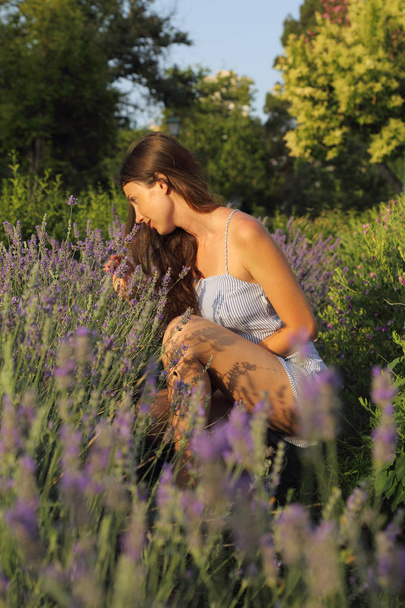 Young woman is enjoying a lavender - Фото, изображение
