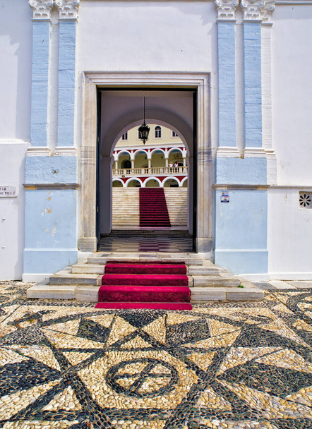 Christian orthodox church of Virgin Mary in Tinos island, Greece, black and white pebbles floor, main entrance, staircase with red carpet. - Photo, Image