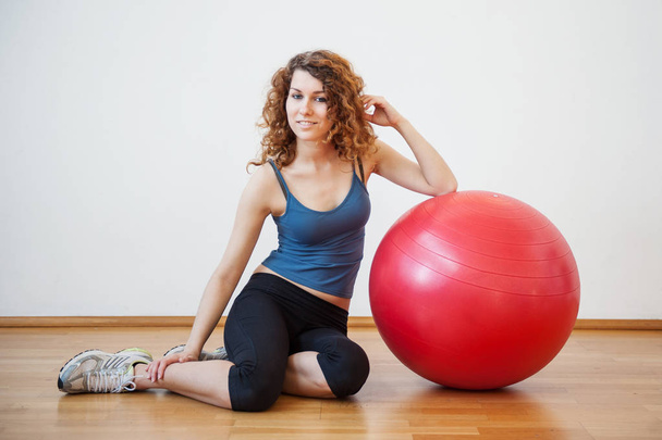 Young woman portrait with ball in the gym.  - Zdjęcie, obraz