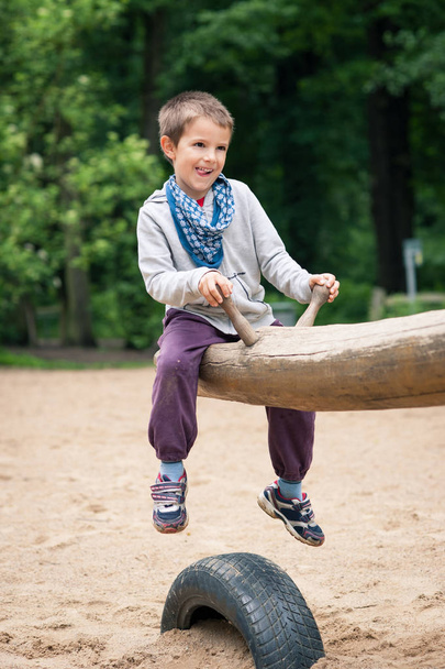 Young kid playing in the park. - Φωτογραφία, εικόνα