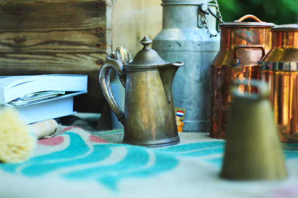 Antique metal jugs and aluminum and copper milk cans on linen tablecloth. - Photo, Image