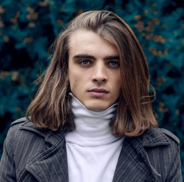 Portrait of young man in white turtle neck  sweater - Фото, зображення