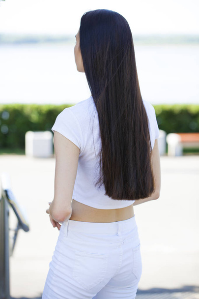 Female brunette hair, rear view, summer park - Fotoğraf, Görsel