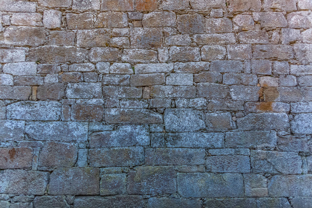 Weergave van patroon met exterieur wand textuur van oud gebouw gemaakt in gepaarde granitische steen - Foto, afbeelding