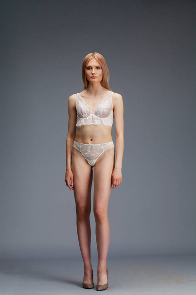 Sexy young blonde woman posing in white underwear  - Valokuva, kuva