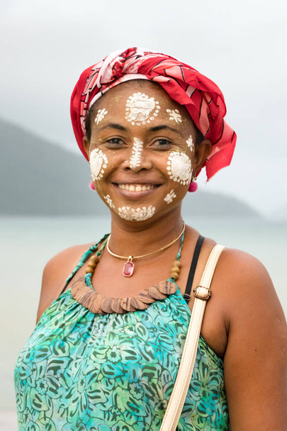 Portrait of a Malagasy woman with her face painted, Vezo-Sakalava tradition, Nosy Be, Madagascar. - 写真・画像