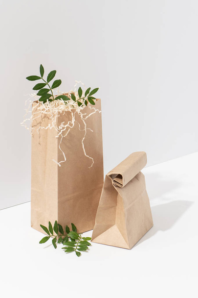 Disposable, recyclable paper eco bags in the corner over white background - Foto, imagen