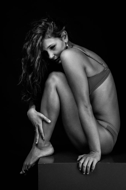 Young intimate woman beauty portrait against dark background. Black and white image.  - 写真・画像