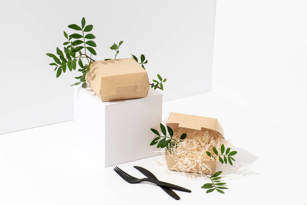 Disposable, recyclable paper hot food boxes in the corner over white background - Foto, Imagen