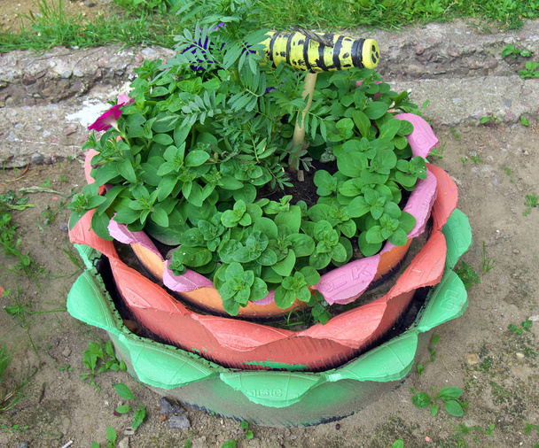 Flowerbed made of several old car tires - Photo, Image