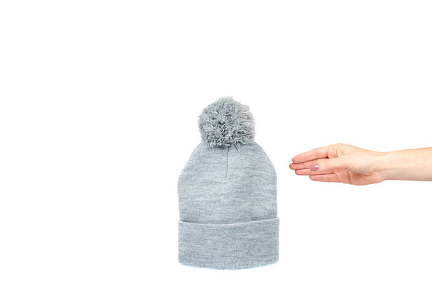 Hand with gray knitted hat, warm woolen accessory. - Foto, immagini