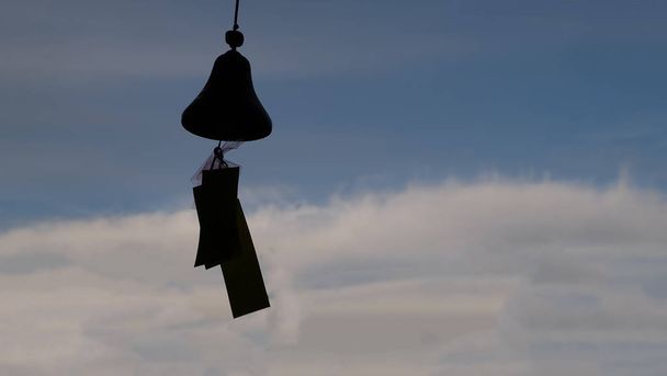 Wind bells chimes compared to the blue sky. - Фото, зображення