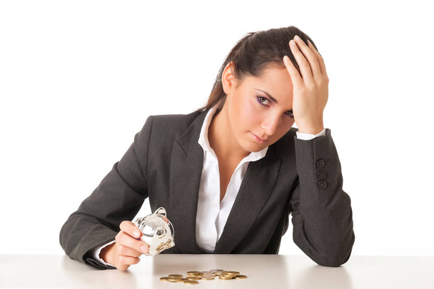 Worried businesswoman counting coins against white background. - Valokuva, kuva