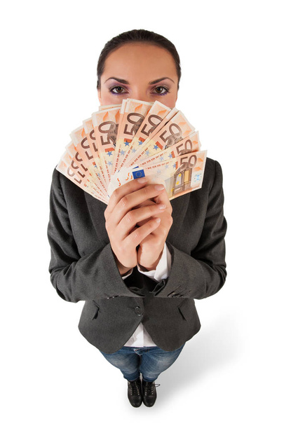 Businesswoman holding euro banknotes hiding herself on white bac - Фото, изображение