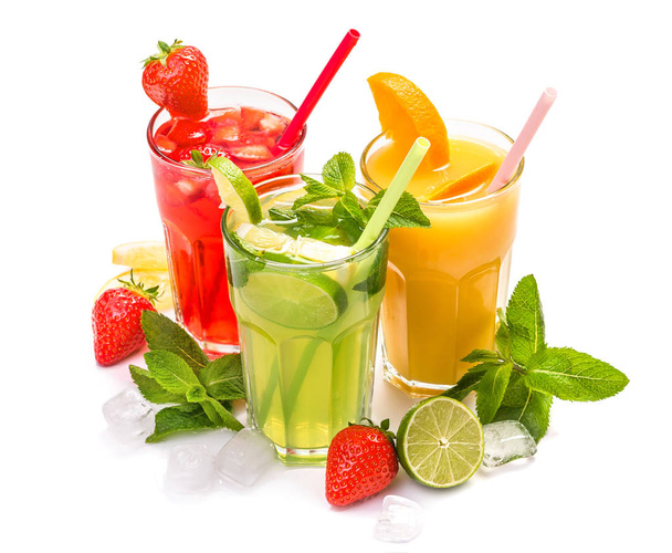 Fruit cocktail in glasses. Fruit drinks made of strawberry, orange, lime, lemon, decorated with mint - Photo, Image