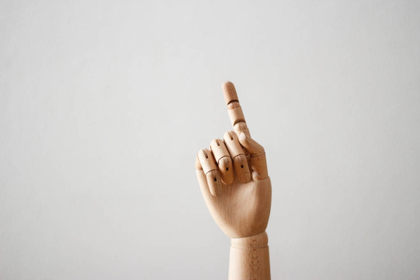 Articulated wood hand on white background - Foto, imagen