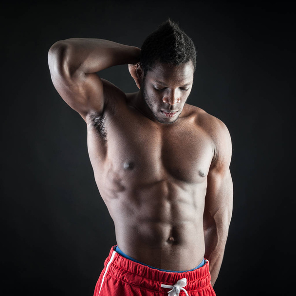 Strong young black man shirtless portrait against black backgrou - Foto, Imagem