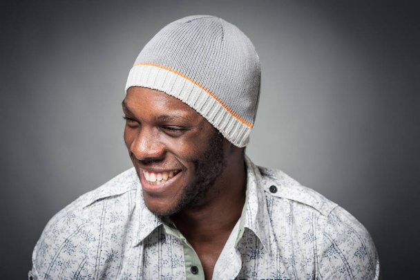 Smiling black man close up portrait against grey background.  - Фото, зображення