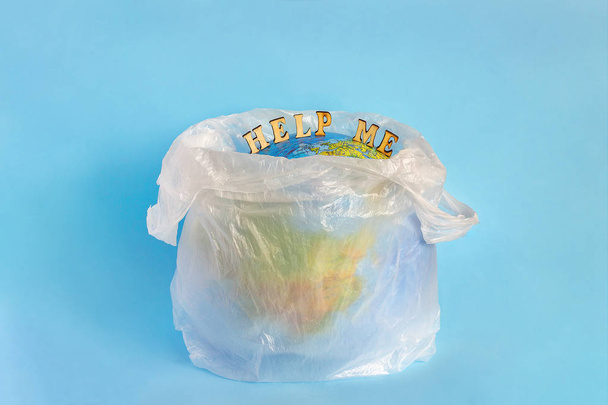 Help me and Model planet Earth in polyethylene plastic package - Fotoğraf, Görsel