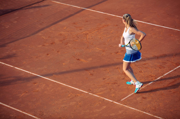 Young woman playing tennis on clay. Forehand. - Φωτογραφία, εικόνα